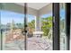 Charming balcony featuring white table and chairs with views of lush greenery at 2200 Bay Blvd # B, Indian Rocks Beach, FL 33785