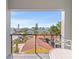 Balcony view of neighborhood with single Gathering home, palm trees and clear blue sky at 2200 Bay Blvd # B, Indian Rocks Beach, FL 33785
