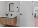 Modern bathroom features a floating vanity with marble countertop, black fixtures and wood-look floor at 2200 Bay Blvd # B, Indian Rocks Beach, FL 33785