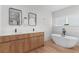 Contemporary bathroom features dual vanity, soaking tub, and marble-look flooring at 2200 Bay Blvd # B, Indian Rocks Beach, FL 33785
