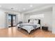 Bright bedroom featuring wood floors, a comfy bed, and doors to a private balcony at 2200 Bay Blvd # B, Indian Rocks Beach, FL 33785