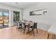 Dining room with a wooden table, black chairs and bright light from the sliding glass doors at 2200 Bay Blvd # B, Indian Rocks Beach, FL 33785