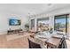 Sun-drenched dining room with hardwood floors and access to a balcony offering picturesque outdoor views at 2200 Bay Blvd # B, Indian Rocks Beach, FL 33785