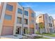 Modern townhouse featuring neutral paint, brown accent wall, and a two-car garage, complemented by fresh landscaping at 2200 Bay Blvd # B, Indian Rocks Beach, FL 33785