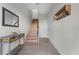 Bright foyer featuring tile floors, a wooden staircase, console table and a charming coat rack at 2200 Bay Blvd # B, Indian Rocks Beach, FL 33785