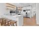 Sleek, modern kitchen with white cabinets, stainless steel appliances, and wood floating shelves at 2200 Bay Blvd # B, Indian Rocks Beach, FL 33785
