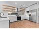 Bright kitchen with modern quartz counters, stainless steel appliances, floating shelves, and a black faucet at 2200 Bay Blvd # B, Indian Rocks Beach, FL 33785