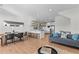 Spacious living room with modern white kitchen, open shelves, and dining area at 2200 Bay Blvd # B, Indian Rocks Beach, FL 33785