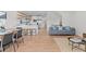 Beautifully designed open concept living room with modern kitchen, dining area, and gray couch at 2200 Bay Blvd # B, Indian Rocks Beach, FL 33785