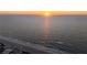 The golden sun sets over a calm ocean, photographed from a beachside community at 2200 Bay Blvd # B, Indian Rocks Beach, FL 33785