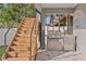 An outdoor kitchen features a built-in gas grill and stainless steel refrigerator below a wooden staircase at 2200 Bay Blvd # B, Indian Rocks Beach, FL 33785