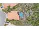 Aerial view of luxurious home with large screened-in swimming pool and lush landscaping at 5802 Hatteras Palm Way, Tampa, FL 33615