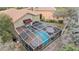 Aerial view of backyard featuring screened-in pool, patio furniture, and tropical landscaping at 5802 Hatteras Palm Way, Tampa, FL 33615