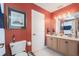 Bright bathroom with a double vanity, framed art, and toilet with ample natural light at 5802 Hatteras Palm Way, Tampa, FL 33615