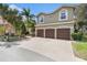 Lovely two-story home with a paver driveway, a three-car garage, and well-maintained landscaping at 5802 Hatteras Palm Way, Tampa, FL 33615