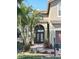 Charming front entrance with an arched door frame, brick walkway and mature landscaping at 5802 Hatteras Palm Way, Tampa, FL 33615