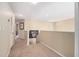 Upstairs hallway featuring carpeted flooring, neutral paint, and views of other rooms at 5802 Hatteras Palm Way, Tampa, FL 33615
