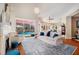 Bright living room with a fireplace, tall ceilings, and views of the outdoor pool area at 5802 Hatteras Palm Way, Tampa, FL 33615
