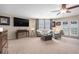 Cozy living room featuring plush seating, a ceiling fan, and sliding glass doors to the outside at 5802 Hatteras Palm Way, Tampa, FL 33615