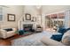 Bright living room featuring a fireplace, plush seating, and sliding glass doors to the outdoor living space at 5802 Hatteras Palm Way, Tampa, FL 33615