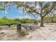 Community park with picnic benches, bbq, and sandy beach near the water at 5802 Hatteras Palm Way, Tampa, FL 33615