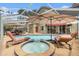 Screened-in pool and spa area, featuring lounge chairs and outdoor living at 5802 Hatteras Palm Way, Tampa, FL 33615