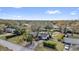 Aerial view of a charming home surrounded by lush landscaping and mature trees at 12205 Kelly Ln, Thonotosassa, FL 33592