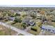 Stunning aerial view of a property with a large yard and mature landscaping in a quiet neighborhood at 12205 Kelly Ln, Thonotosassa, FL 33592