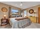 Bright bedroom with decor, bed, wood paneling, and carpet at 12205 Kelly Ln, Thonotosassa, FL 33592