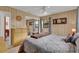 A cozy bedroom with paneling, ceiling fan, and comfortable-looking paisley bedding at 12205 Kelly Ln, Thonotosassa, FL 33592