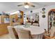 View of the dining room, kitchen, and living room with table, chairs, and decor at 12205 Kelly Ln, Thonotosassa, FL 33592