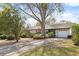 Beautiful home with a well-kept lawn, mature landscaping, and an attached two-car garage at 12205 Kelly Ln, Thonotosassa, FL 33592
