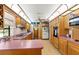 Bright kitchen featuring ample cabinetry, a ceiling fan, and lots of counter space and lighting at 12205 Kelly Ln, Thonotosassa, FL 33592