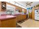 Bright kitchen featuring wooden cabinets, light wood floor, and a ceiling fan at 12205 Kelly Ln, Thonotosassa, FL 33592