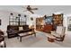 Cozy living room with comfortable seating, ceiling fan, and a large window for natural light at 12205 Kelly Ln, Thonotosassa, FL 33592