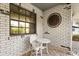 Inviting outdoor patio with a decorative metal sun and cozy seating for relaxing outside at 12205 Kelly Ln, Thonotosassa, FL 33592