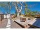 Inviting backyard with a wooden deck, outdoor seating, mature trees, and storage shed at 1767 Colorado Ne Ave, St Petersburg, FL 33703