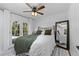 Cozy bedroom with french doors, ceiling fan, and decorative rug at 1767 Colorado Ne Ave, St Petersburg, FL 33703