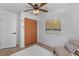 Bedroom with a ceiling fan, closet, and light colored chair at 1767 Colorado Ne Ave, St Petersburg, FL 33703