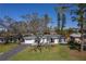 Inviting single-story home with a well-manicured lawn, an attached garage and mature shade trees at 1767 Colorado Ne Ave, St Petersburg, FL 33703