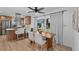 Open-concept dining area with modern bar stools and a sliding door at 1767 Colorado Ne Ave, St Petersburg, FL 33703