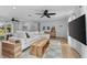 Bright living room featuring a large sectional sofa, wood accents, and modern decor at 1767 Colorado Ne Ave, St Petersburg, FL 33703