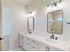 Bathroom with double sinks, white cabinets and marble countertops at 3603 Lajuana Blvd, Wesley Chapel, FL 33543