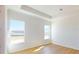 A bright bedroom with two windows and wood laminate flooring at 3603 Lajuana Blvd, Wesley Chapel, FL 33543