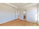 Bedroom featuring two windows and wood laminate flooring at 3603 Lajuana Blvd, Wesley Chapel, FL 33543