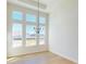 Bright dining room featuring a modern chandelier and large windows at 3603 Lajuana Blvd, Wesley Chapel, FL 33543