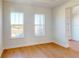 Bright living room featuring large windows and light hardwood floors at 3603 Lajuana Blvd, Wesley Chapel, FL 33543