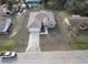 A stunning aerial view of a charming one-story home with ample parking space and lush trees at 383 Yeager St, Port Charlotte, FL 33954