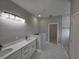 Modern bathroom features a double vanity, stone countertop and sleek lighting fixtures at 383 Yeager St, Port Charlotte, FL 33954
