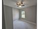 Cozy bedroom featuring a ceiling fan, a window with natural light, and tile floors at 383 Yeager St, Port Charlotte, FL 33954